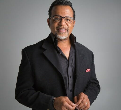 Carlton Pearson smiling in black suit