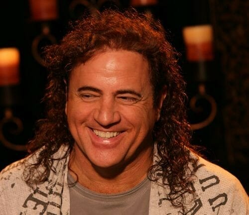 Kim Clement smiling in long hair