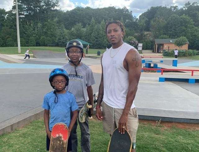 Lecrae with his sons in a park